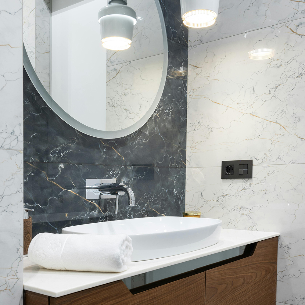 Commercial hotel LED mirror illuminating a luxury hotel bathroom